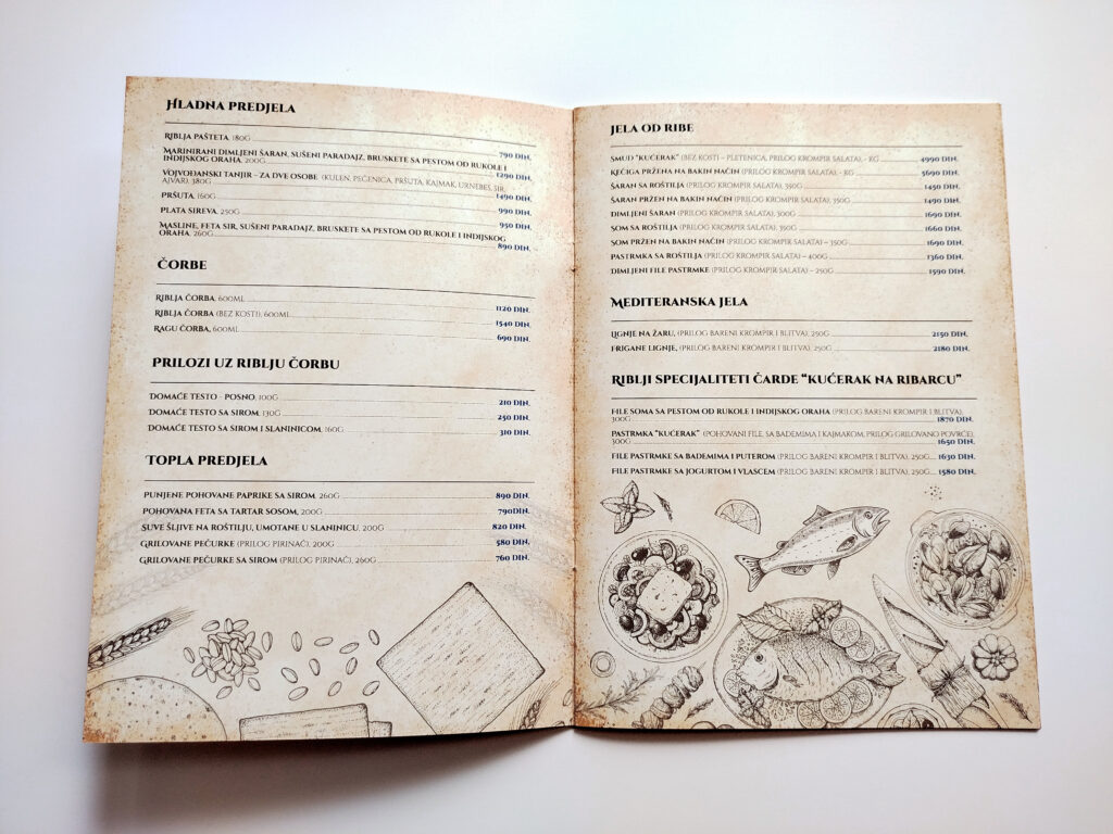 Otvoreni jelovnik restorana sa elegantnim rasporedom ponude jela i dekorativnim ilustracijama